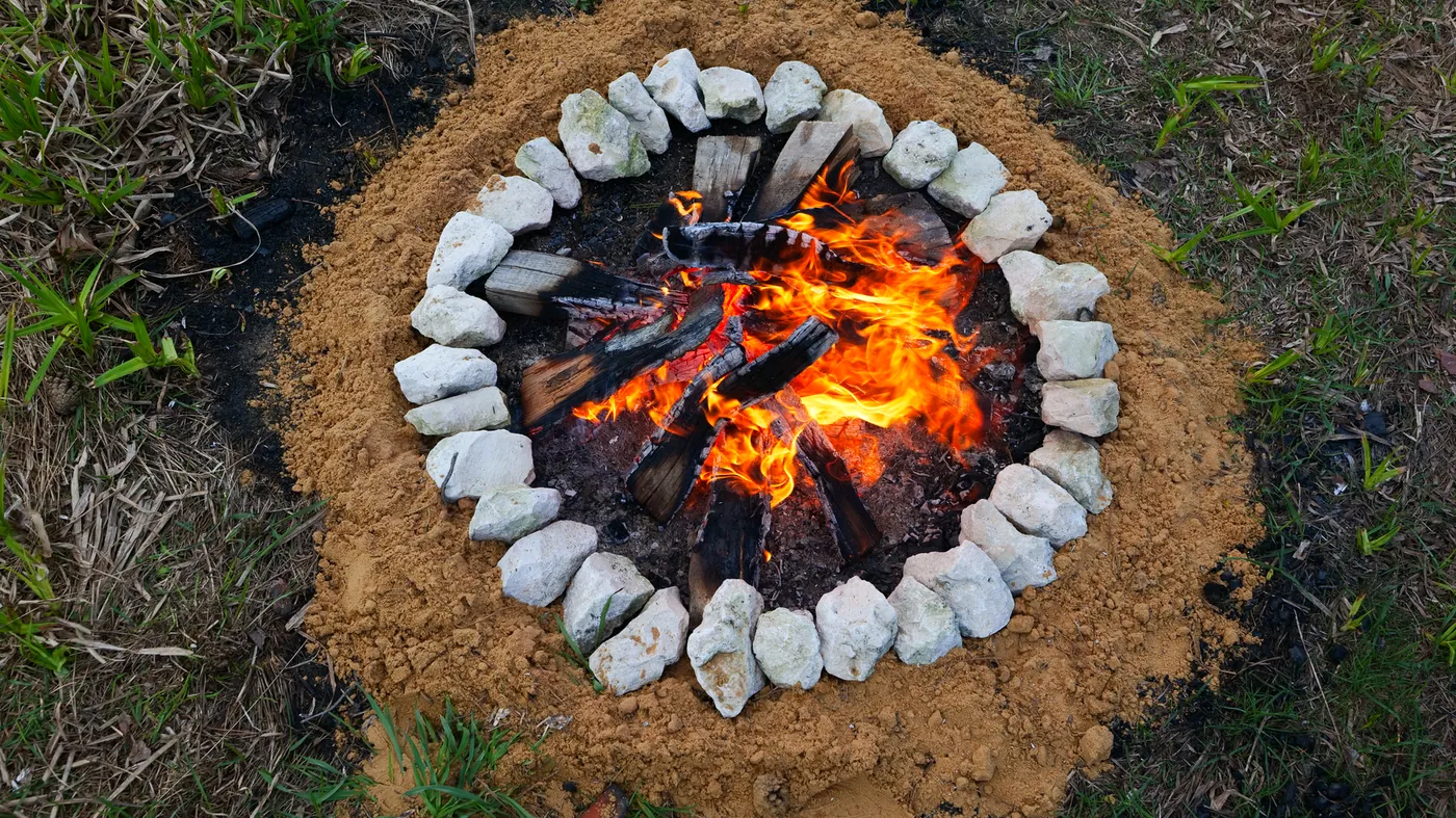 A campfire burning inside a ring of stones