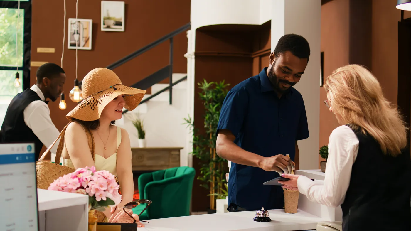 Guests checking in at a hotel reception desk