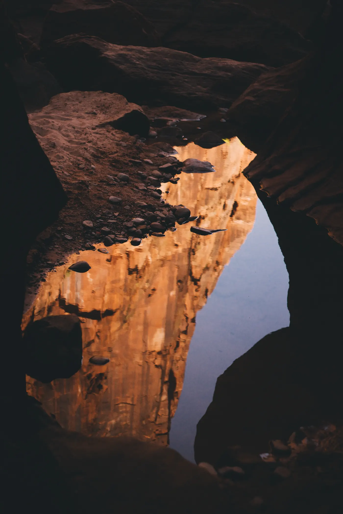 Inside a cave, with soft light reflecting on still water