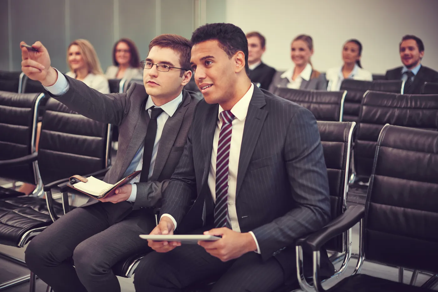Delegates seated in rows at a conference session