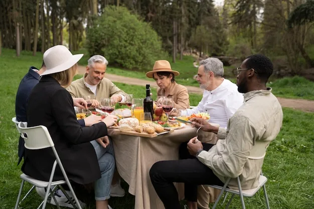 A group sharing lunch and wine at an outdoor table