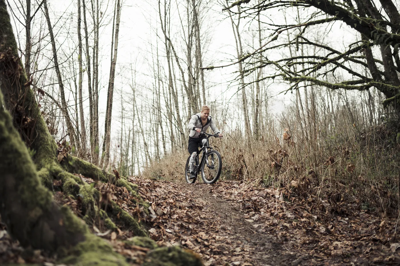 Mangapurua Track riders need off-road skills: a mountain biker on a leaf-covered forest trail