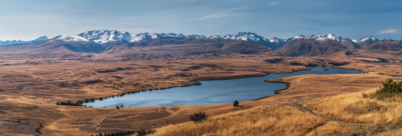 A high-country lake near Tekapo below snow-capped mountains