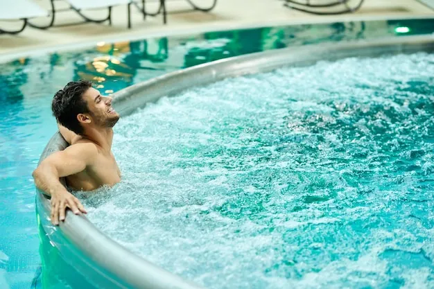 A guest relaxing in a bubbling spa pool